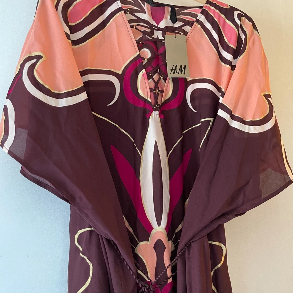 Long caftan with string tassels.